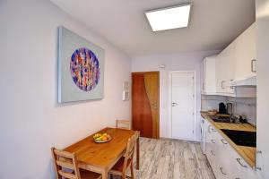 a kitchen with a wooden table in a room at vv CASCO HISTÓRICO SEA VIEWS in Santa Cruz de la Palma
