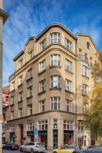 a large building with cars parked in front of it at Templova 6 Old Town Apartment in Prague