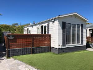 a house with a fence in front of it at Zee en duin in IJmuiden