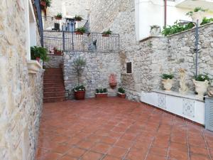 einen Innenhof in einem Steingebäude mit Topfpflanzen in der Unterkunft casa Marino in Capaccio-Paestum