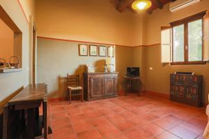 a living room with a tiled floor and a tv at AGRITURISMO LE CORTI DELLA GUALDANA in Voghera