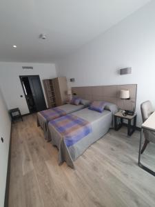 Postel nebo postele na pokoji v ubytování HOTEL IBERUM