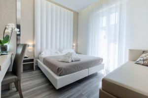 Postel nebo postele na pokoji v ubytování Hotel Stella D'Oro