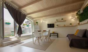 a living room with a bed and a table and chairs at Stesicoro Exclusive House in Catania