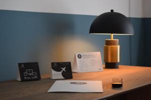 a desk with a lamp and a book on it at Soho Boutique Las Vegas in Málaga