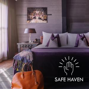 a bedroom with a bed with a safe haven sign on it at Canal House in Amsterdam