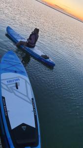 a person sitting on a paddle board in the water at Marise Holiday Home in Õeste