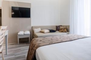 Postel nebo postele na pokoji v ubytování Hotel Stella D'Oro