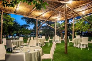 a group of tables and chairs under a pergola at Hotel Alpha in Sant'Agnello