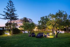 a group of chairs sitting in a park at night at Hotel Alpha in Sant'Agnello