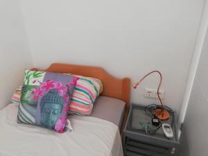 a bed with a pillow and a lamp on it at Villa Giulia in Korčula