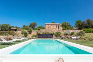 an image of a swimming pool in front of a house at Albero Capovolto in Golfo Aranci
