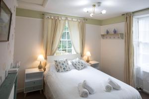 1 dormitorio con 1 cama blanca y 2 toallas en Rydal Lodge, en Rydal