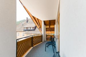a view from the balcony of a house with a desk at Moderne 2 Zi.-FeWo BlackForest Art Barrierefrei Nähe Freiburg in Simonswald