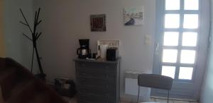 a bedroom with a dresser with a coffee maker on it at Le gîte de l'atelier in Lailly-en-Val