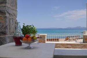 a bowl of fruit on a table with a view of the ocean at Moutsouna Beach in Moutsouna Naxos