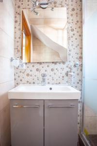 a bathroom with a white sink and a mirror at Sani villa perfect for family vacations in Sani Beach