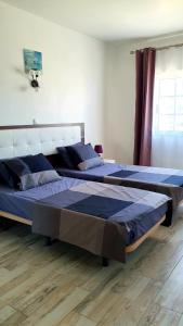 Säng eller sängar i ett rum på Dunas 142