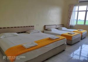 Ein Bett oder Betten in einem Zimmer der Unterkunft Soo Guan Villa