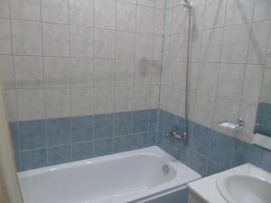 a bathroom with a tub and a sink at Хотел Флора private studio All seasons in Borovets +16 photos