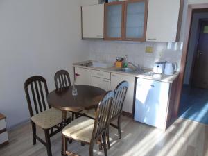 a kitchen with a table and chairs and a table and a sink at Хотел Флора private studio All seasons in Borovets