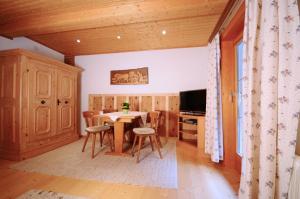 a kitchen with a table and chairs in a room at Ahnenhöfl in Partenen