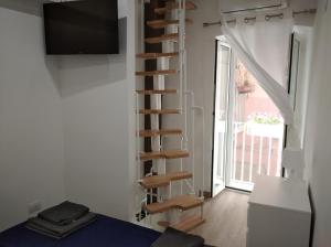 a spiral staircase in a room with a window at Mattia's house 2 in Bari