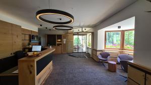 an office with a hallway with chairs and a desk at Hotel Cresta in Samnaun