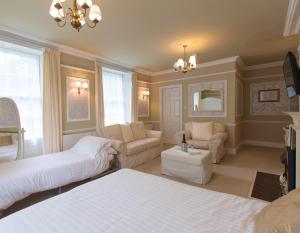 a bedroom with two beds and a living room at Rydal Lodge in Rydal
