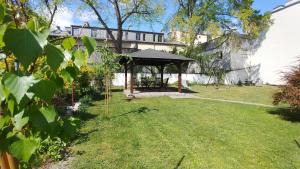 a gazebo in the yard of a house at Apartamenty Patria in Krakow