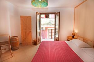 a bedroom with a large bed with a red blanket at Taormina Bed and BeerCraft in Taormina
