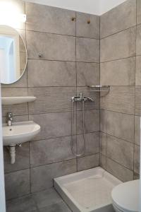 a bathroom with a shower and a toilet and a sink at Moutsouna Beach in Moutsouna Naxos
