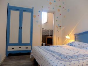 a bedroom with a bed and a blue door at La Vecchia Latteria - B & B in Gardone Riviera