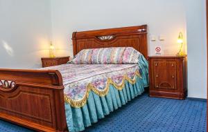 a bedroom with a bed and two night stands at Astoria Lux in Dnipro