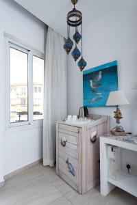 a small room with a dresser and a lamp at Hotel Opera in Larnaka