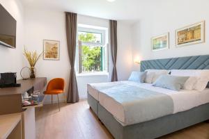 - une chambre avec un lit, un bureau et une fenêtre dans l'établissement Green Park Luxury Rooms, à Split