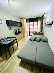 - une chambre avec 2 lits, un bureau et une table dans l'établissement Studio Acapulco, à Lloret de Mar