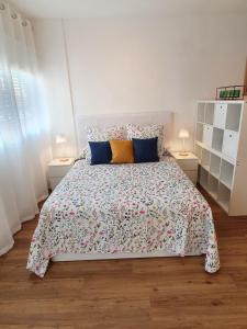 a bedroom with a large bed with two lamps at La Casita del Reloj in Santa Cruz de la Palma