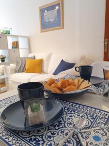 a table with a plate of bread and a cup on it at La Casita del Reloj in Santa Cruz de la Palma +9 photos