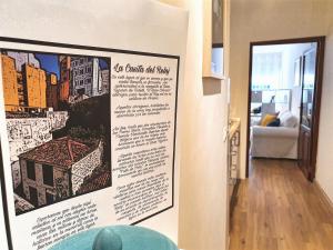 a poster hanging on a wall in a living room at La Casita del Reloj in Santa Cruz de la Palma