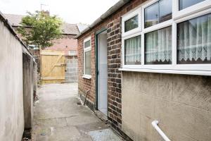 a brick building with a window and a door at Stay Comfortable-City Centre Location- Sleeps up to 9 in Stoke on Trent