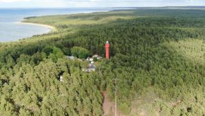 an aerial view of a lighthouse in the middle of a forest at Paradise Beach Surf Bungalow Medium in Kalana