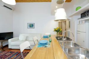 a kitchen with a sink and a table in a kitchen at RomeAsYouLike - Colosseo Experience 23 in Rome
