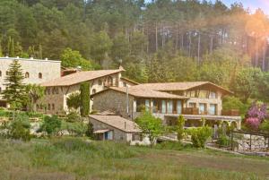 a large house in the middle of a field at El Jou Nature in Sant Corneli de Cercs 