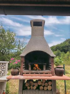 a brick oven with a fire inside of it at Studio apartman Firdaus-Bihać, Dobrenica bb in Bihać