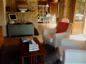 a living room with two chairs and a table at Majellame in Caramanico Terme
