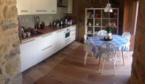 a kitchen with a table and chairs in a kitchen at Majellame in Caramanico Terme