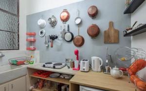 a kitchen with pots and pans hanging on the wall at House in House at the Heart of Exarchia, extremely central in Athens