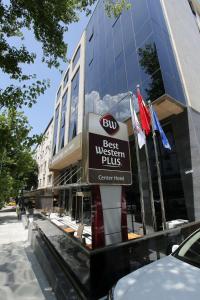 a sign on a pole in front of a building at Best Western Plus Center Hotel in Ankara