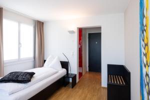 Ένα ή περισσότερα κρεβάτια σε δωμάτιο στο Hotel Bauernhof - Self Check-In Hotel